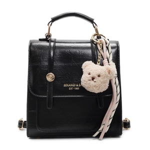 Classic black leather backpack for women with teddy bear charm and woven ribbon detail