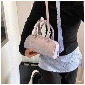 Detail of lavender patent leather handbag with pleated texture and silver hardware
