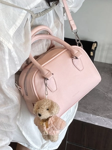 Pink pebbled leather bowling handbag with teddy bear charm and silver hardware accessories