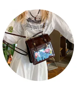 Detail of a dark brown PU leather itabag featuring a large clear display window for decoration