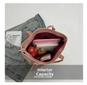 Top view showing large interior capacity of straw tote bag with pink straps