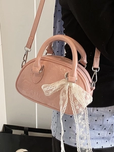 Pink patent leather mini Boston bag with white lace bow and embossed patterns for women