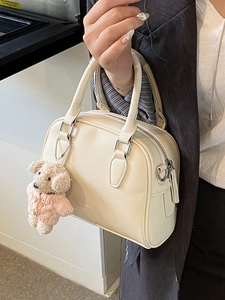 Chic cream white pebbled leather bowling bag with twin handles and cute puppy charm