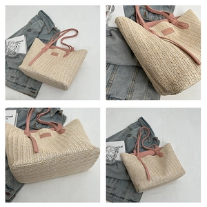 Detail view of woven straw tote bag featuring pink leather handles and V-shape texture