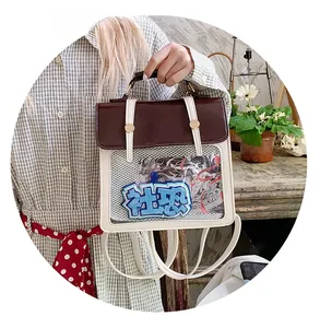 Close-up of clear window detail on white and brown leather backpack with decorative card