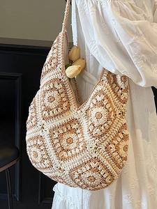 Bohemian crochet tote bag with geometric floral patterns and large capacity on a model