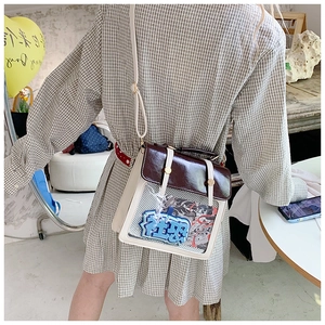 Detail of clear display window on contrast color ita bag with anime character inserts