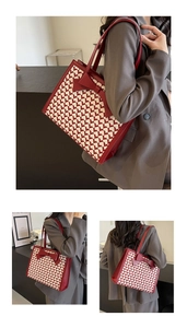 Detail of red bow on heart pattern tote bag with leather straps for women