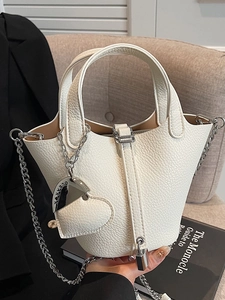 Chic white lychee pattern bucket bag with heart pendant and silver chain strap