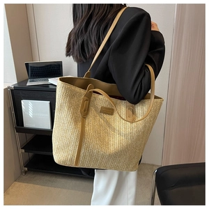 Detailed side view of the woven tote bag showing large capacity and khaki shoulder straps