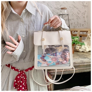 Detail view of cream white PU leather ita bag with a large clear window and anime artwork