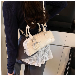 Creamy white bowling bag with heart pearl charm detail and textured faux leather finish