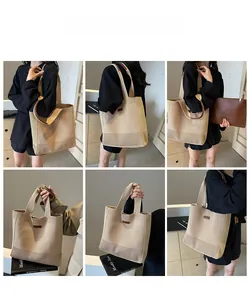 Detail view of woven straw tote bag featuring brown leather handles and large capacity