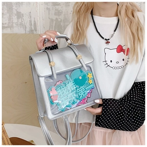 Detail of silver ita bag with transparent display window and cute decorative mint green tag