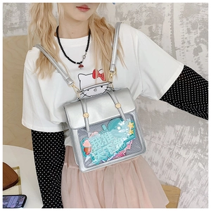 Detail of silver Ita bag showing the transparent mesh window and decorative pins