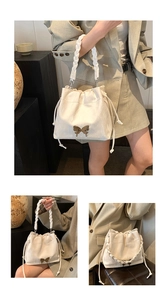Detail of drawstring bucket bag with gold butterfly accent and woven handle texture