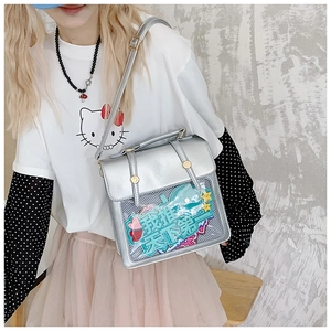 Detail view of silver PU leather ita bag with transparent window and blue whale card