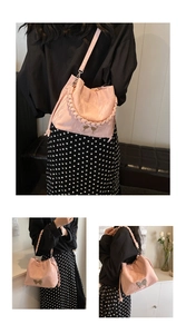Detailed views of a pink pleated bucket bag with braided handle and bow clasp hardware