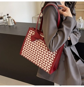 Detail of red bow and houndstooth panel on this elegant large tote shoulder bag