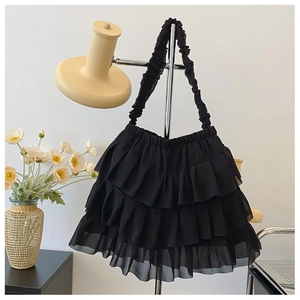 Detailed view of black tote bag featuring three-layer ruffled cake skirt design and pleats
