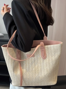 Large cream woven tote bag with pink leather trim and dual straps shown on a model