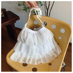 Close-up of white multi-layered ruffle shoulder bag made of soft chiffon fabric