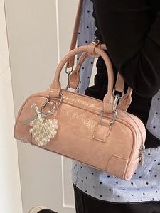 Pink glossy leather bowling bag with heart pearl charm and logo embossing
