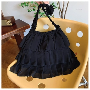 Detail of black tiered ruffle shoulder bag with soft chiffon pleats and layered design