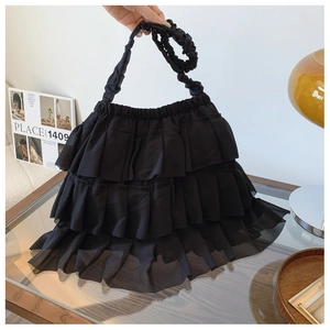 Detail of black tiered ruffle tote bag featuring layered chiffon and scrunched shoulder strap