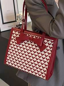 Elegant red and cream heart pattern tote bag with large bow and leather handles