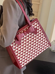 Red jacquard heart pattern tote bag with large leather bow and dual shoulder handles