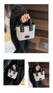 Détail du sac seau bicolore avec tissage beige et poignées en cuir noir chic
