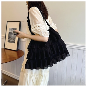 Detail view of the black tiered ruffle shoulder bag with soft chiffon pleats for women