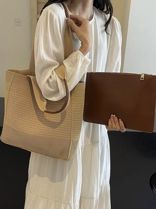 Minimalist woven tote bag with brown leather pouch shown on model in a modern interior