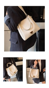 Detail view of lychee pattern leather bucket bag with gold hardware and logo