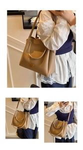 Close-up of brown lychee grain leather tote bag featuring a gold triangular metal logo