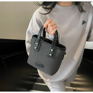Détails du sac seau gris foncé avec anneaux en D dorés et poignées à rivets