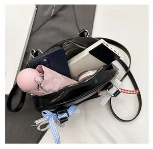 Top view of black patent leather bag showing large interior capacity for daily essentials
