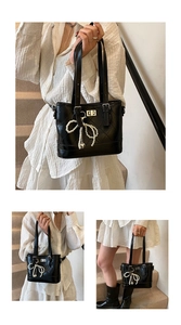 Detailed view of black quilted bucket bag featuring a pearl bow charm and metal buckle