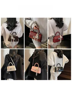 Detailed view of minimalist square crossbody bag with metal buckle and woven strap ornament
