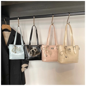 Close-up of quilted leather tote bags in four colors with pearl bow heart charms