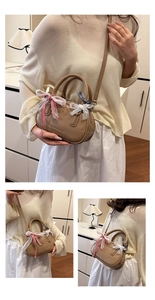 Detail view of mini beige crossbody bag with lace bows and plaid ribbon accents