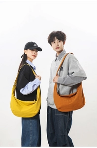 Detailed view of yellow and orange nylon crescent bags on models with wide straps
