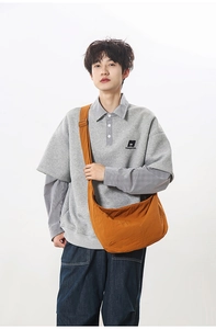 Detail view of large nylon crescent crossbody bag in bright orange for daily casual wear
