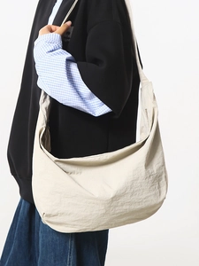 Ivory nylon crescent hobo bag with wide shoulder strap for casual daily commuting