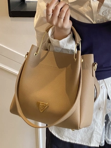 Brown lychee leather tote bag with gold metal handles and triangle logo for workwear