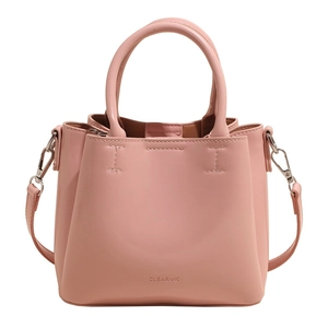 Chic pink bucket handbag for women with smooth PU leather finish and crossbody strap