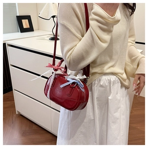 Red retro Boston bag with lace details and plaid ribbon on a female model