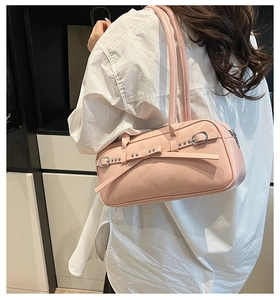 Detailed back view of pink bowling bag featuring a decorative bow and silver rivets
