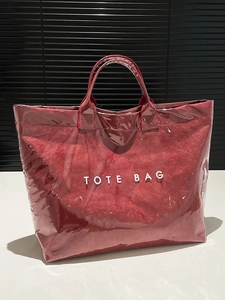 Large red DuPont paper tote bag with clear PVC overlay and bold TOTE BAG lettering